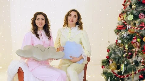 Two girls having fun in their pajamas near the Christmas tree 스톡 동영상 70043089