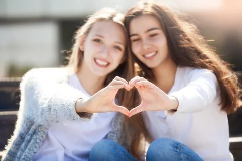 Two Girls Holding Hands in Shape of Heart Stock Photos