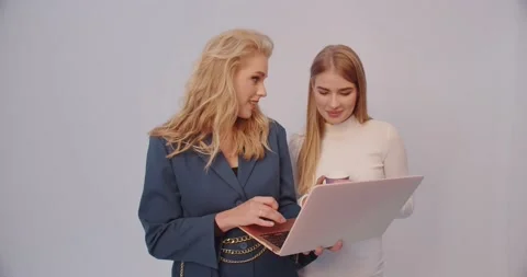 Two Girls On A Laptop Create An Image For A Photo Shoot Stock Footage 235317394