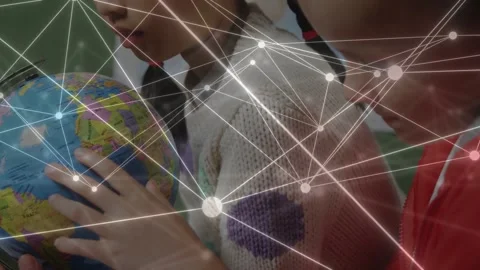 Two girls leaning in placing hand, rotating globe for education while nodes Stock Footage 334703128