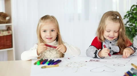 Two girls learn to paint sitting at the table. DOLLY HD Video stock 8956855