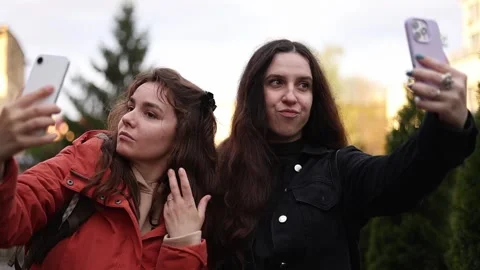 Two girls make content on their phone Stock Footage 309794815