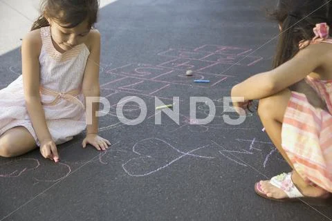 Two Girls Making Chalk Drawings