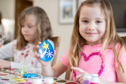Two Girls Making Easter Decorations At Home Stock Photos