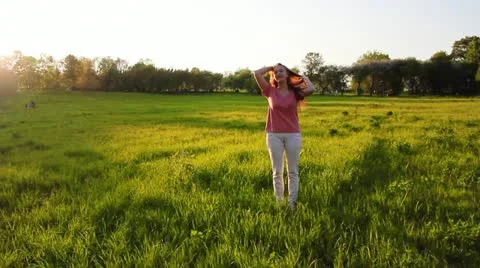 Two girls in a meadow Stock Footage 11017400