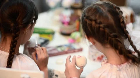 Two girls painting Easter eggs Stock Footage 48376296
