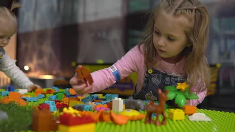 Two girls play constructor on the playground. Stock Footage 150338713