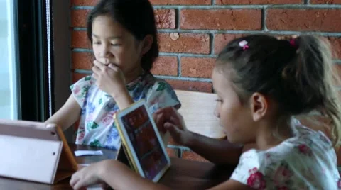 Two girls play tablet Stock Footage 64237781