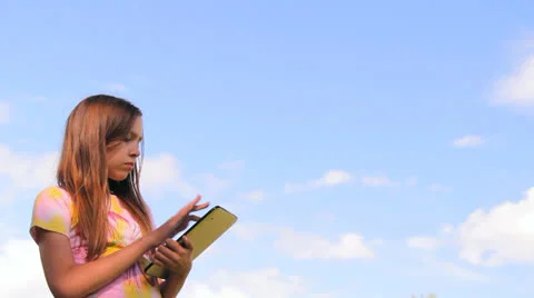 Two girls play work with a tablet, iPad, the laptop Stock Footage 25326867