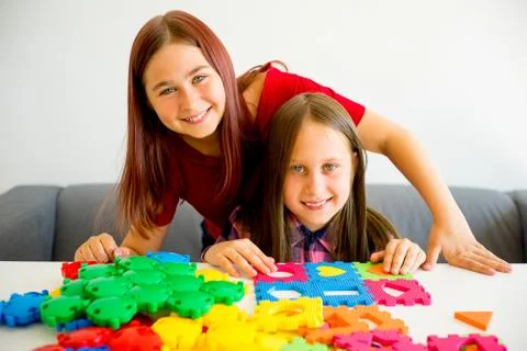 Two girls playing with construction blocks Stock Photos