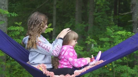 Two girls playing on the hammock Stock Footage 92801955