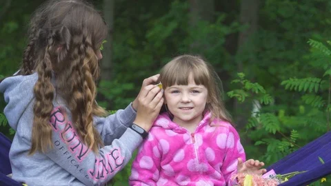Two girls playing on the hammock Stock Footage 93081130
