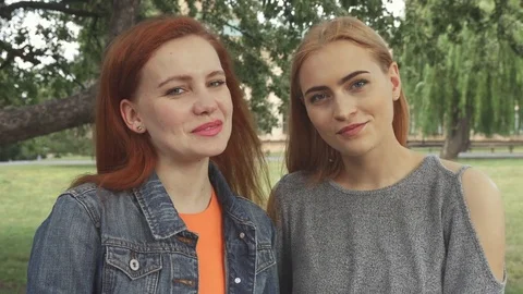 Two girls posing for a camera Stock Footage 79848574