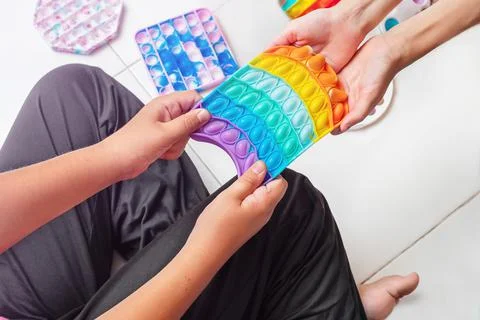 Two girls pull rubber toy Stock Photos