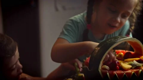 Two girls received a basket-shaped melon as a gift. The girl is very happy. 4k Stock Footage 157444466