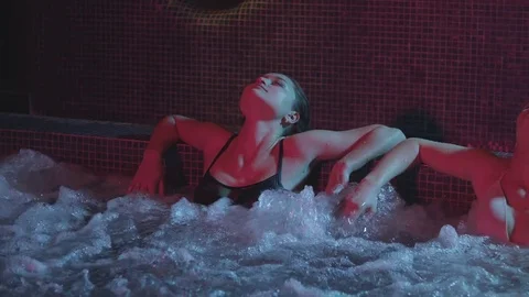 Two girls relax in the jacuzzi Stock Footage 85069780