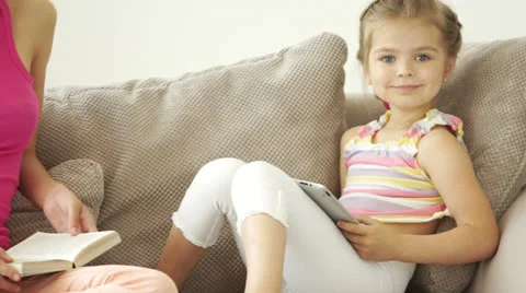 Two girls sitting on the couch Stock Footage 24568166