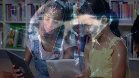 Two girls sitting in library tapping tablets, mesh forming globe between them Stock Footage 331214110