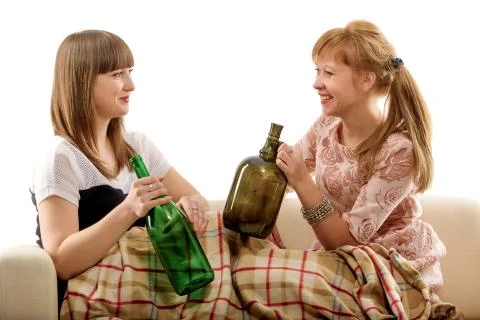 Two girls on a sofa after drinking wine Stock Photos