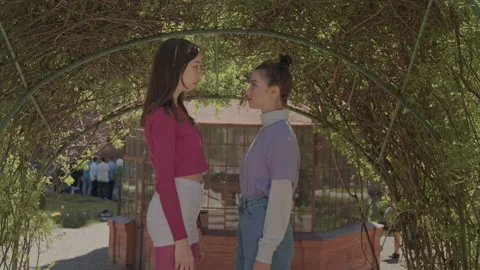 Two girls stand facing each other in each other's eyes and then quickly into the Vídeo Stock 159266466