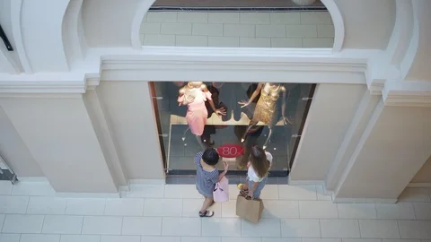 Two girls standing before window display Stock Footage 97997611