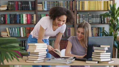 Two girls study by book laptop Stock Footage 89649544