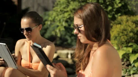 Two girls with tablet on vacation Stock Footage 26242186