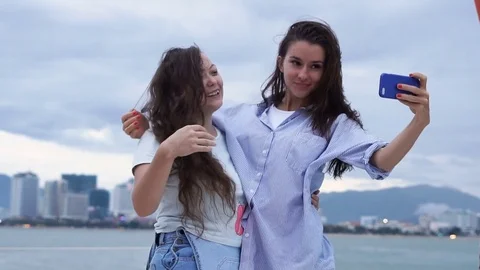 Two girls taking selfie while enjoying a cruise on a yacht Stock Footage 79827819