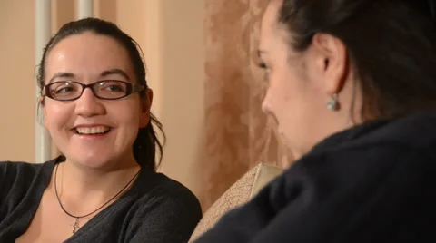 Two girls talking on sofa, focus from first to second Stock Footage 34294193