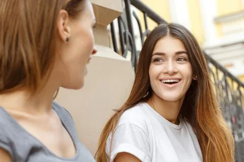 Two girls talking, while chilling out in city Stock Photos