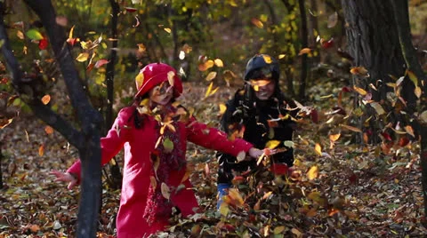 Two girls throwing fall leaves Video stock 24670583