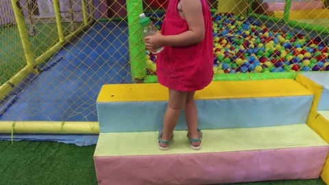 Two girls at a trampoline with multi-colored balls Video stock 78216113