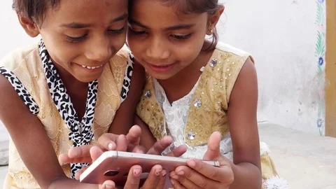 Two girls using a touchscreen device together, handheld  Stock Footage 69872982