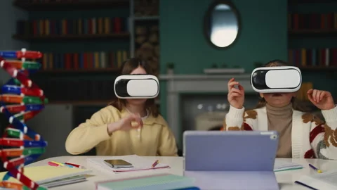 Two girls using VR headsets for digital education, interactive learning Stock Footage 346719887