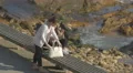 Two girls watching their phone on the sidewalk along the ocean, Porto 4k or 4k+ Resolution