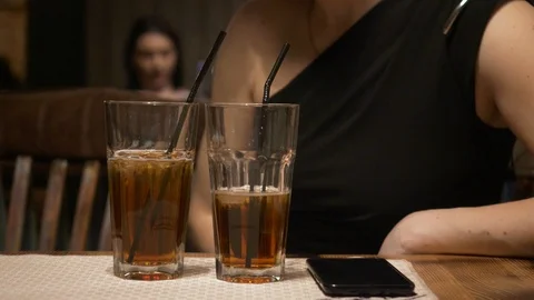 Two glass of cocktails on the table foreground. Stock Footage 86384243