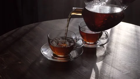Two glass cups with black tea on a wooden table Stock Footage 169089401