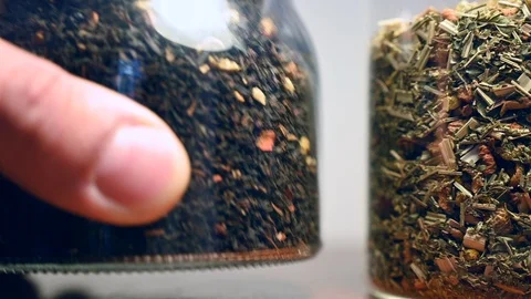 Two glass jars full of mixture herbs tea condiment Stock Footage 105134406