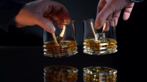 Two glass tea cups clank, slow motion against dark background, biting frost Stock Footage 153530804