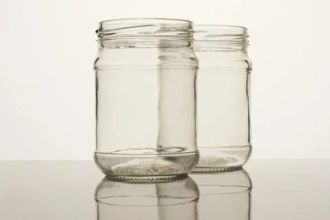 Two glass transparent empty jars. Stock Photos