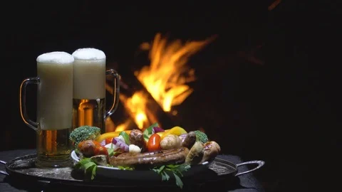 Two glasses of beer on the background of fire Stock Footage 79749631