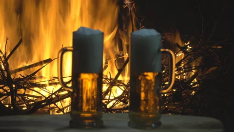 Two glasses of beer on fire background, dolly shot Stock Footage 96482997