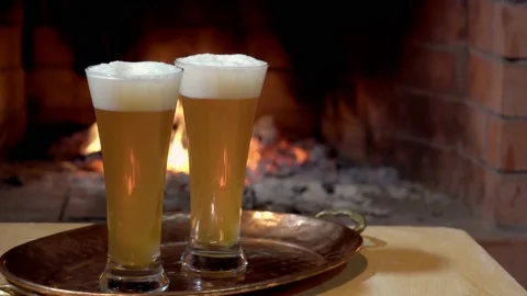 Two glasses of beer on fire background, dolly shot Stock Footage 163761765