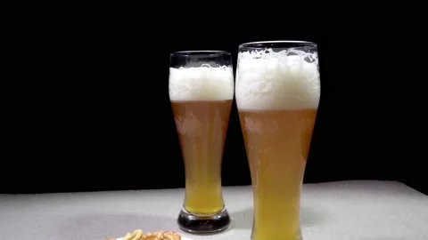 Two glasses of beer in a minimalist interior, dolly shot Stock Footage 154963745