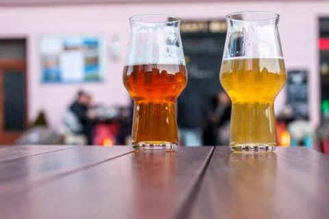 Two glasses of beer on table edge Stock Photos