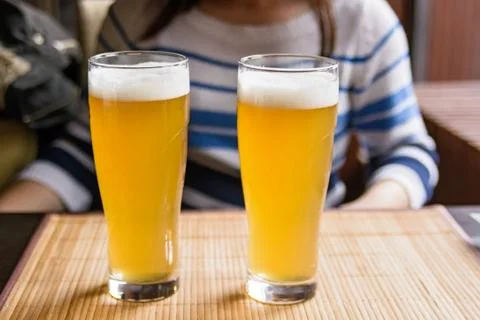 Two glasses of beer on a table in restaurant Stock Photos