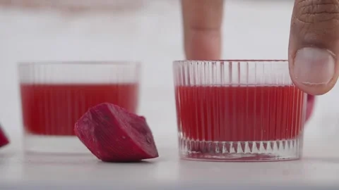 Two glasses of beetroot juice sit on a table. Stock Footage 329204276