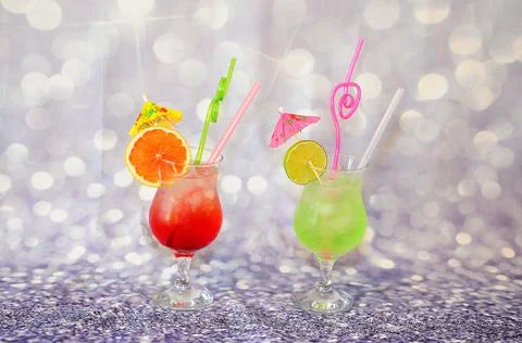 Two glasses with bright fruit drinks and slices of citrus lime and grapefruit Stock Photos