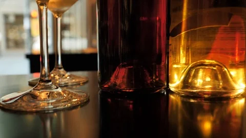Two glasses of champagne and different colors bottles of wine exhibition in the Stock Footage 92306797