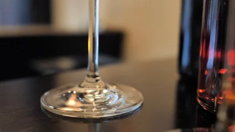 Two glasses of champagne and different colors bottles of wine exhibition in the Stock Footage 92306971